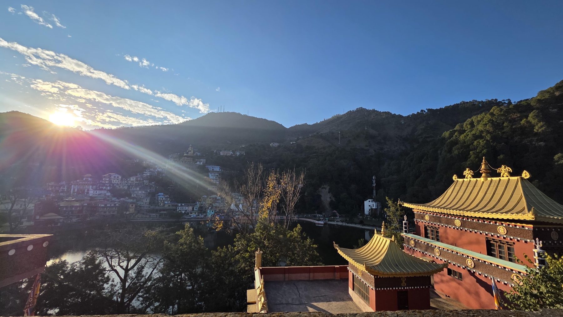 Monastery buildings overlooking the lake and surrounding hills at sunrise