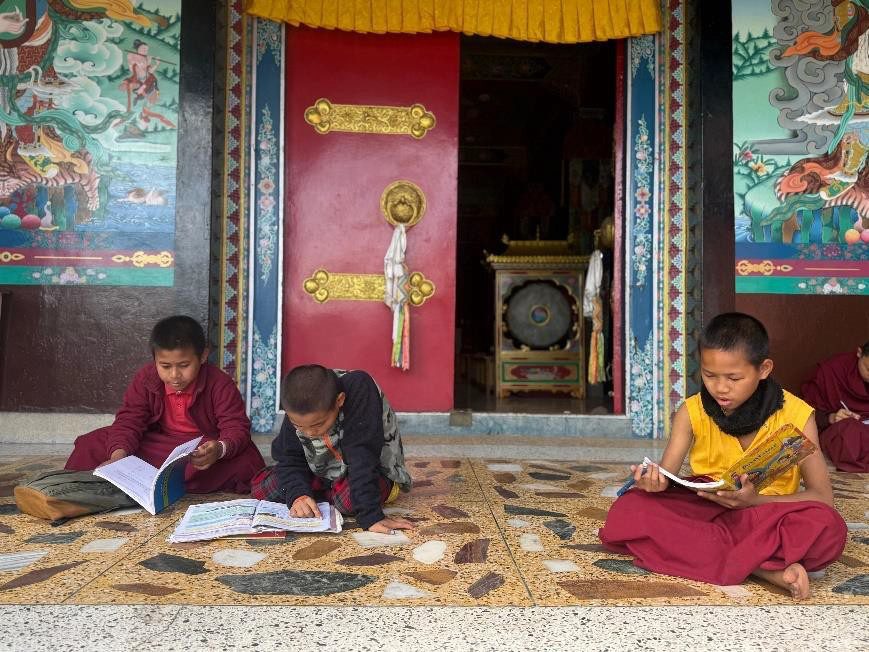 Young monks studying at the monastery doorway