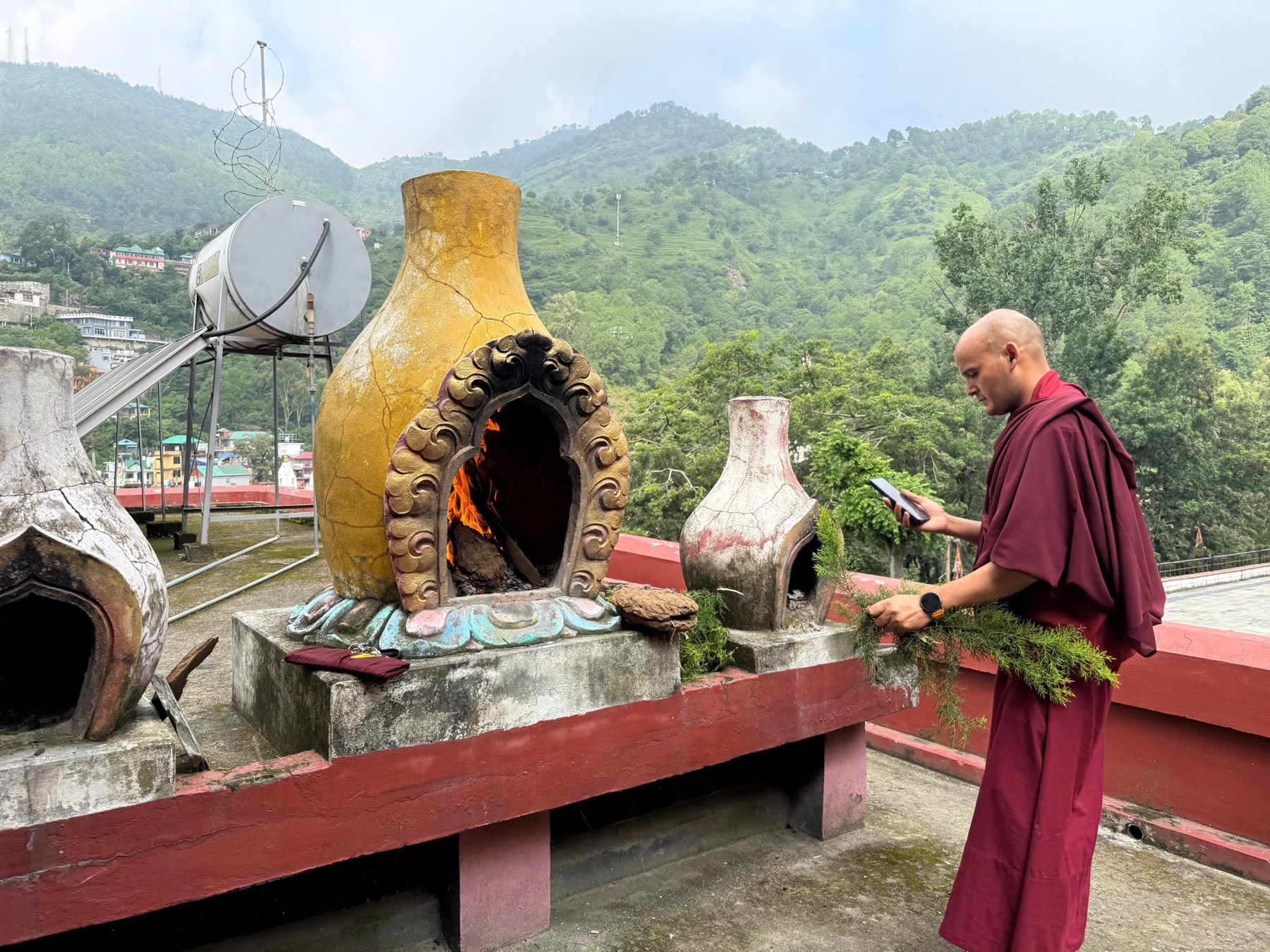 A monk tending the ritual fire during the project blessing puja