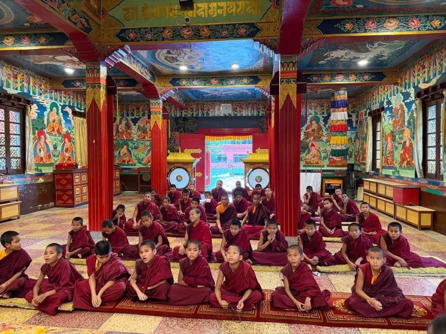 Children assembled in the colourful monastery shrine hall